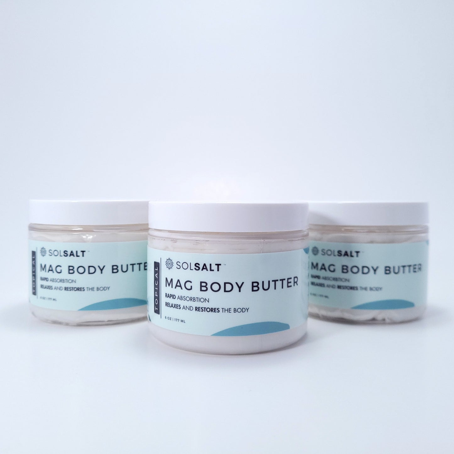 Three 6 oz jars labeled 'SOL SALT' on a light gray background. Nourishing magnesium body butter for soft skin & muscle relief. Creamy, non-greasy.