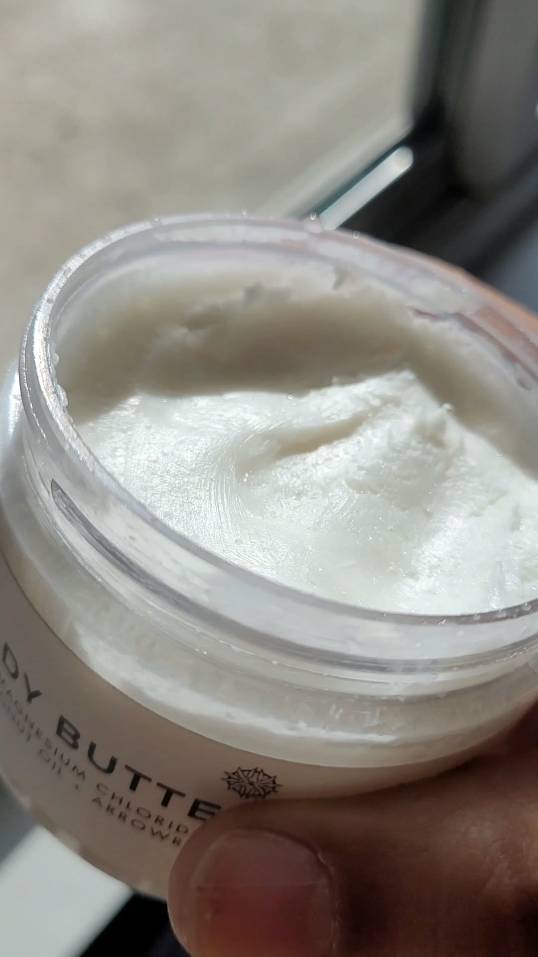 6 oz jar labeled 'SOL SALT' close-up of the creamy consistency of the body butter. Nourishing magnesium body butter for soft skin & muscle relief. Creamy, non-greasy.