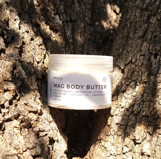 6 oz jar labeled 'SOL SALT' nestled within a tree nook. Nourishing magnesium body butter for soft skin & muscle relief. Creamy, non-greasy. 