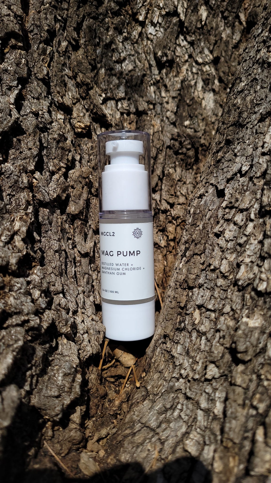 30 mL pump bottle labeled "SOL SALT" nestled within a tree nook. Easy-pump magnesium gel for targeted relief. Non-greasy, fast-acting.